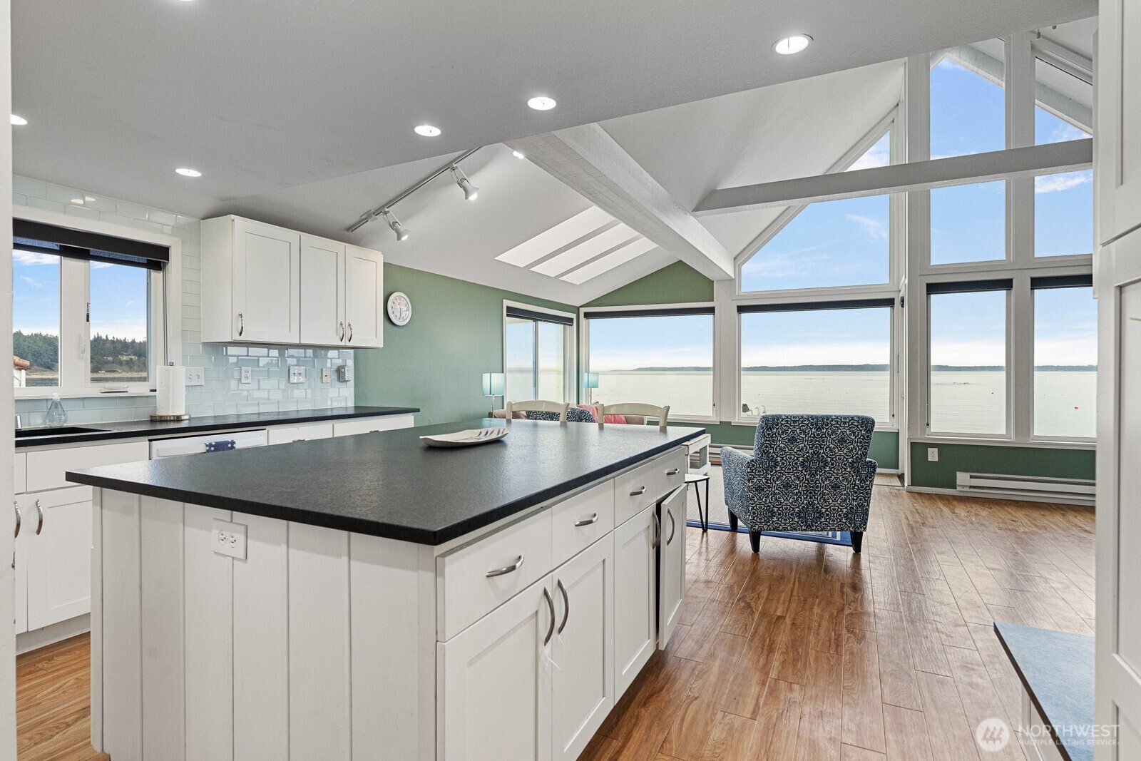2508 Sunlight Beach Road Clinton, WA 98236 - Photo 10 of 33 a kitchen with stainless steel appliances granite countertop a sink a stove and a wooden floors