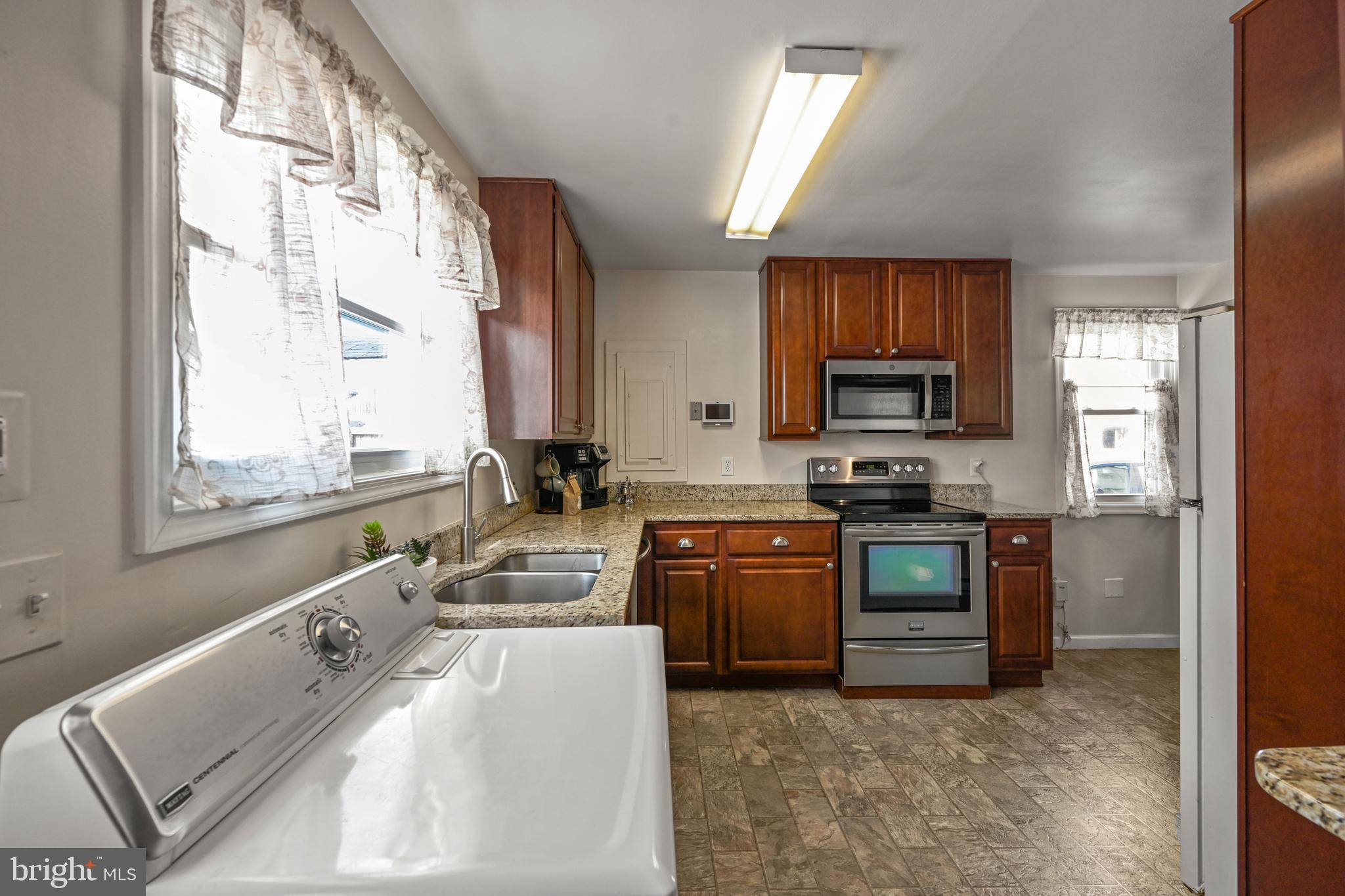 1027 Upton Road Glen Burnie, MD 21060 - Photo 20 of 39 a kitchen with stainless steel appliances granite countertop a sink stove and refrigerator