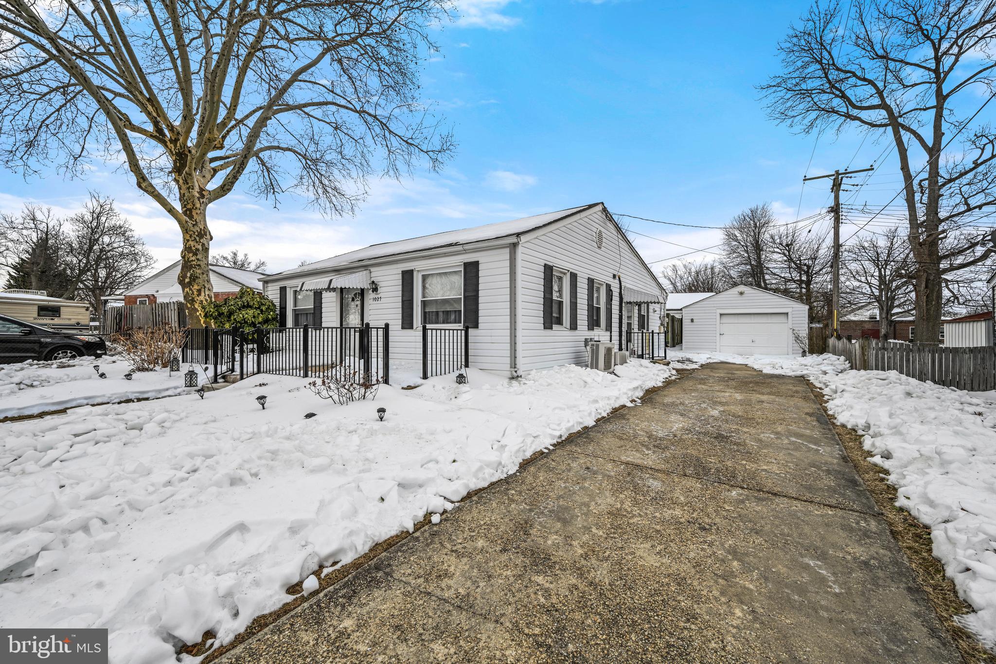 1027 Upton Road Glen Burnie, MD 21060 - Photo 2 of 39 a view of a white house with a snow on the road