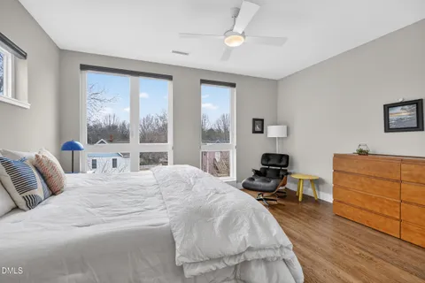 a spacious bedroom with a large bed and a large window