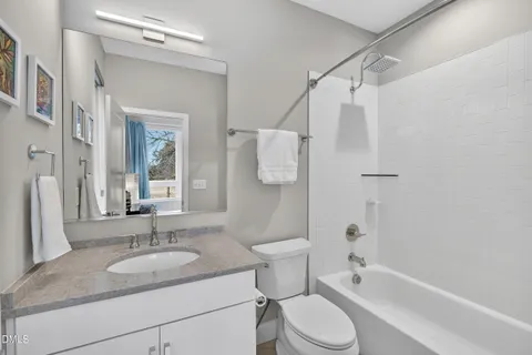 a bedroom with furniture and a large window