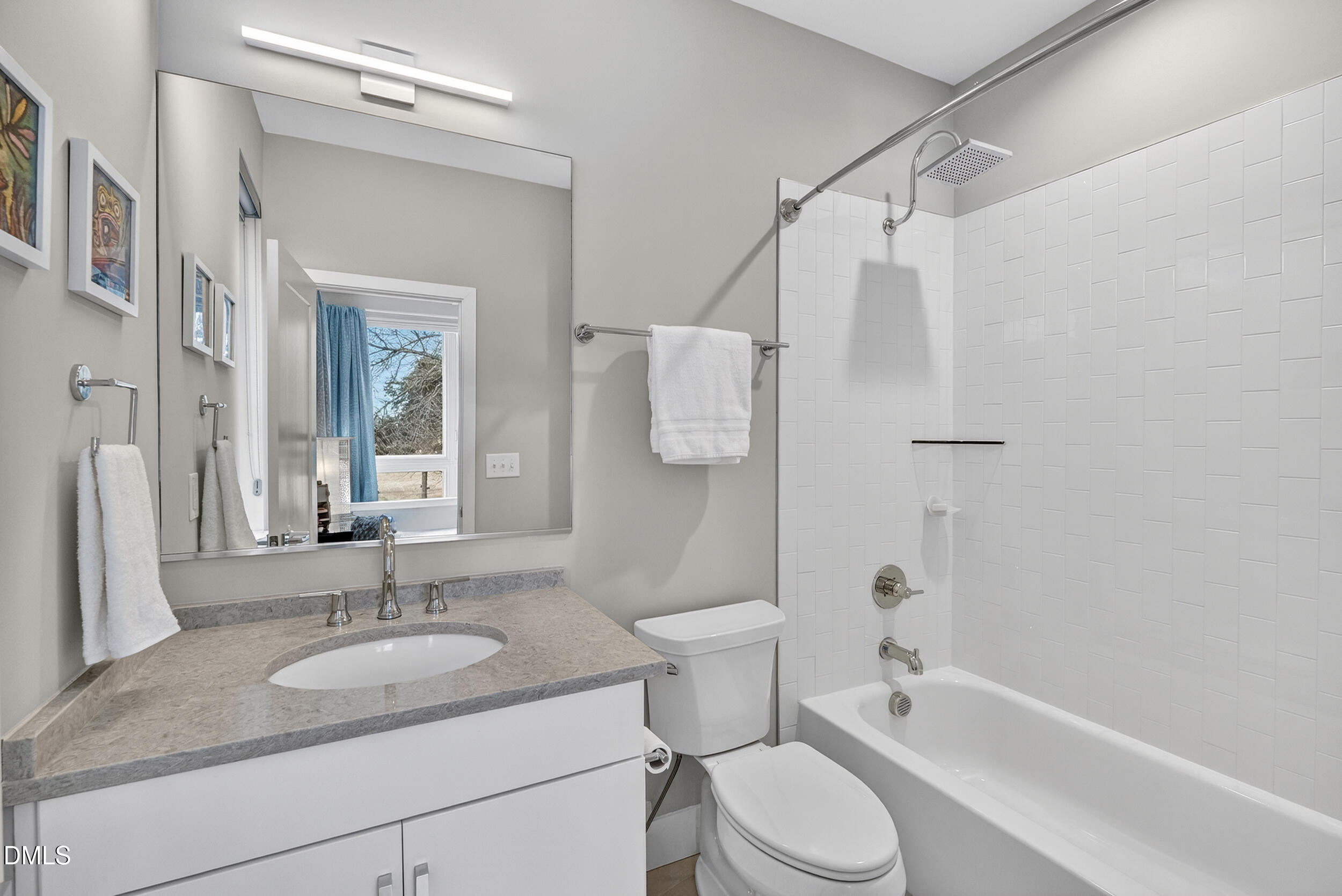 537 New Bern Avenue, Unit 101 Raleigh, NC 27601 - Photo 20 of 34 a bathroom with a granite countertop sink toilet and shower