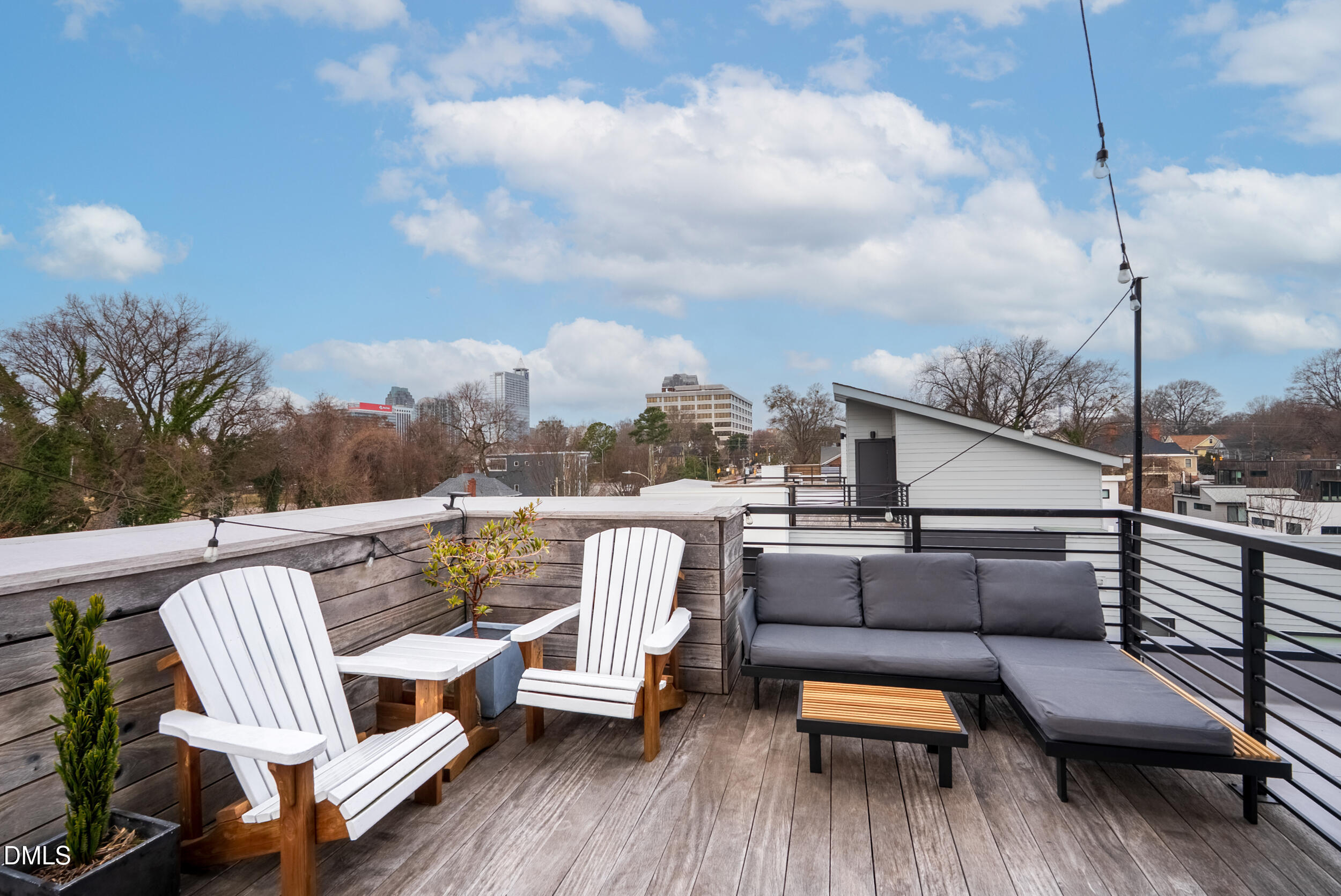 537 New Bern Avenue, Unit 101 Raleigh, NC 27601 - Photo 24 of 34 a balcony with wooden floor and outdoor seating