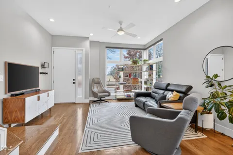 a living room with furniture a rug and a chandelier