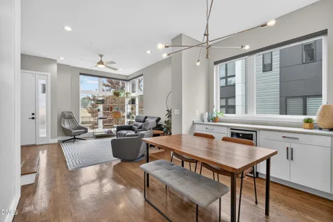 a kitchen with kitchen island a wooden floor and white appliances