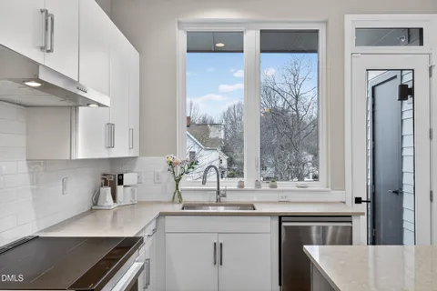 a kitchen with stainless steel appliances a sink stove and refrigerator