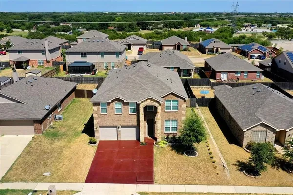an aerial view of a house with a yard