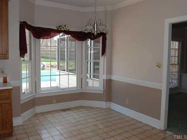 10808 Brass Kettle Road Raleigh, NC 27614 - Photo 3 of 12 The inviting breakfast room offers a ceramic tile floor, designer neutral wall paint, painted chairrail and crown molding, chandelier, bay window and is a wonderful place for the family to gather in the morning Other