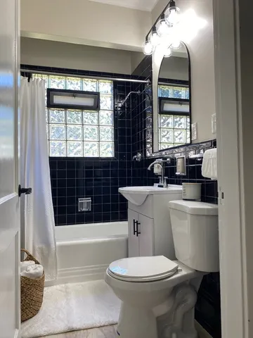 a bathroom with a toilet a sink and bathtub