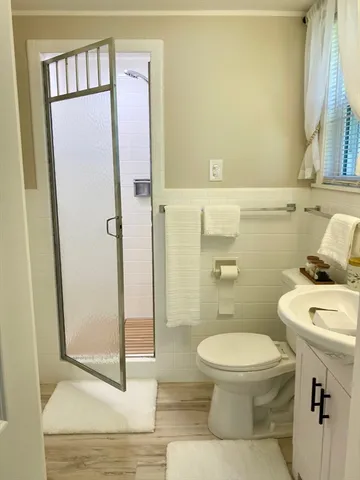 a bathroom with a toilet a sink and a shower