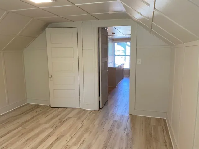 a view of hallway with wooden floor