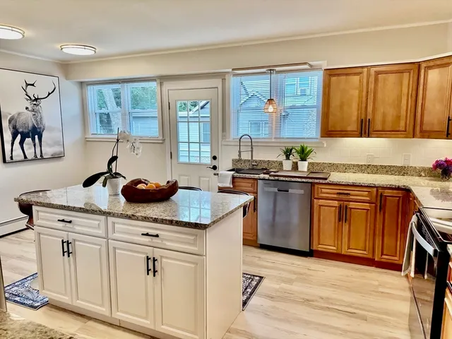 a kitchen with stainless steel appliances granite countertop a sink stove and refrigerator