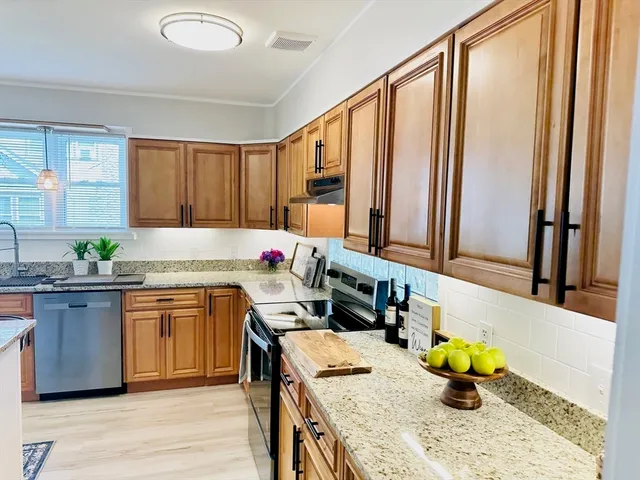 a kitchen with a sink appliances and cabinets