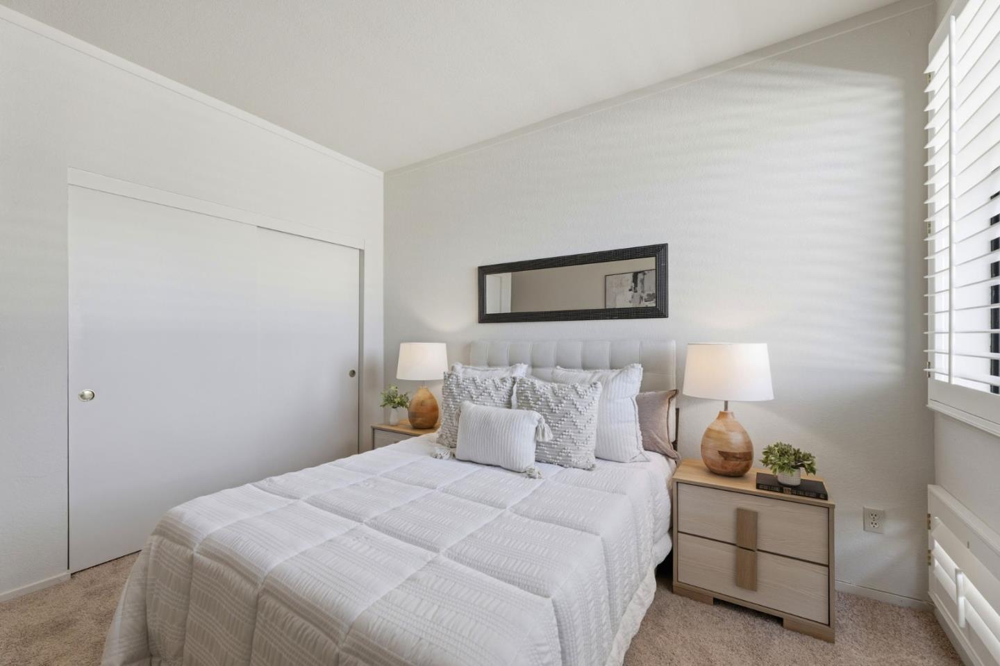 22330 Homestead Road, Unit 226 Cupertino, CA 95014 - Photo 28 of 38 a bedroom with a bed and a lamp on the dresser