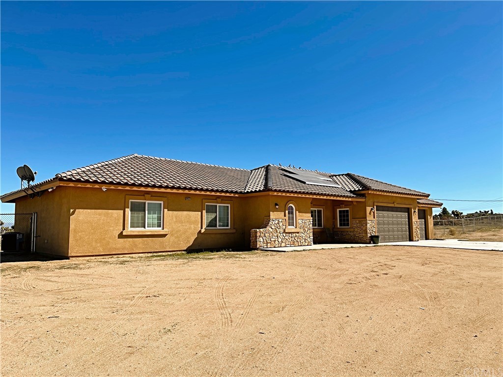 9477 Buttemere Road Phelan, CA 92371 - Photo 1 of 1 a front view of a house with a yard