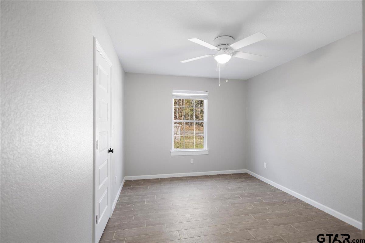 234 Sabinal Street Bullard, TX 75757 - Photo 12 of 30 an empty room with a window and a fan