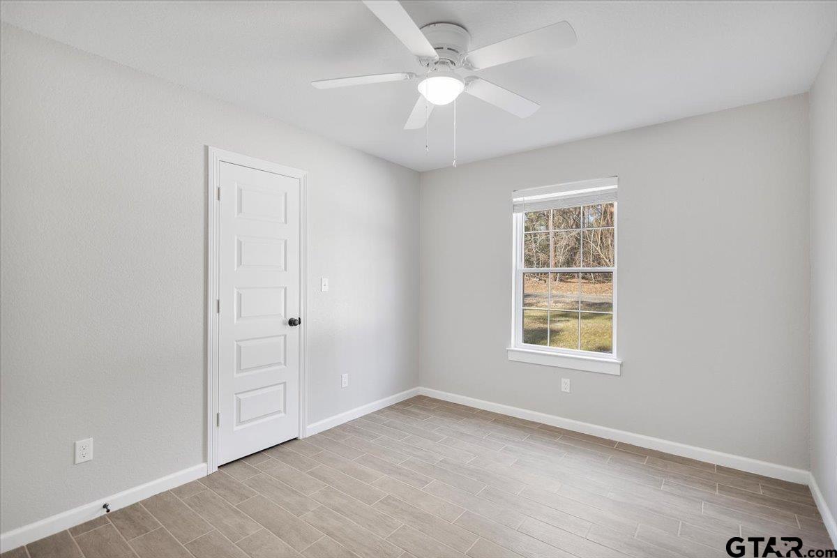 234 Sabinal Street Bullard, TX 75757 - Photo 13 of 30 an empty room with windows and fan
