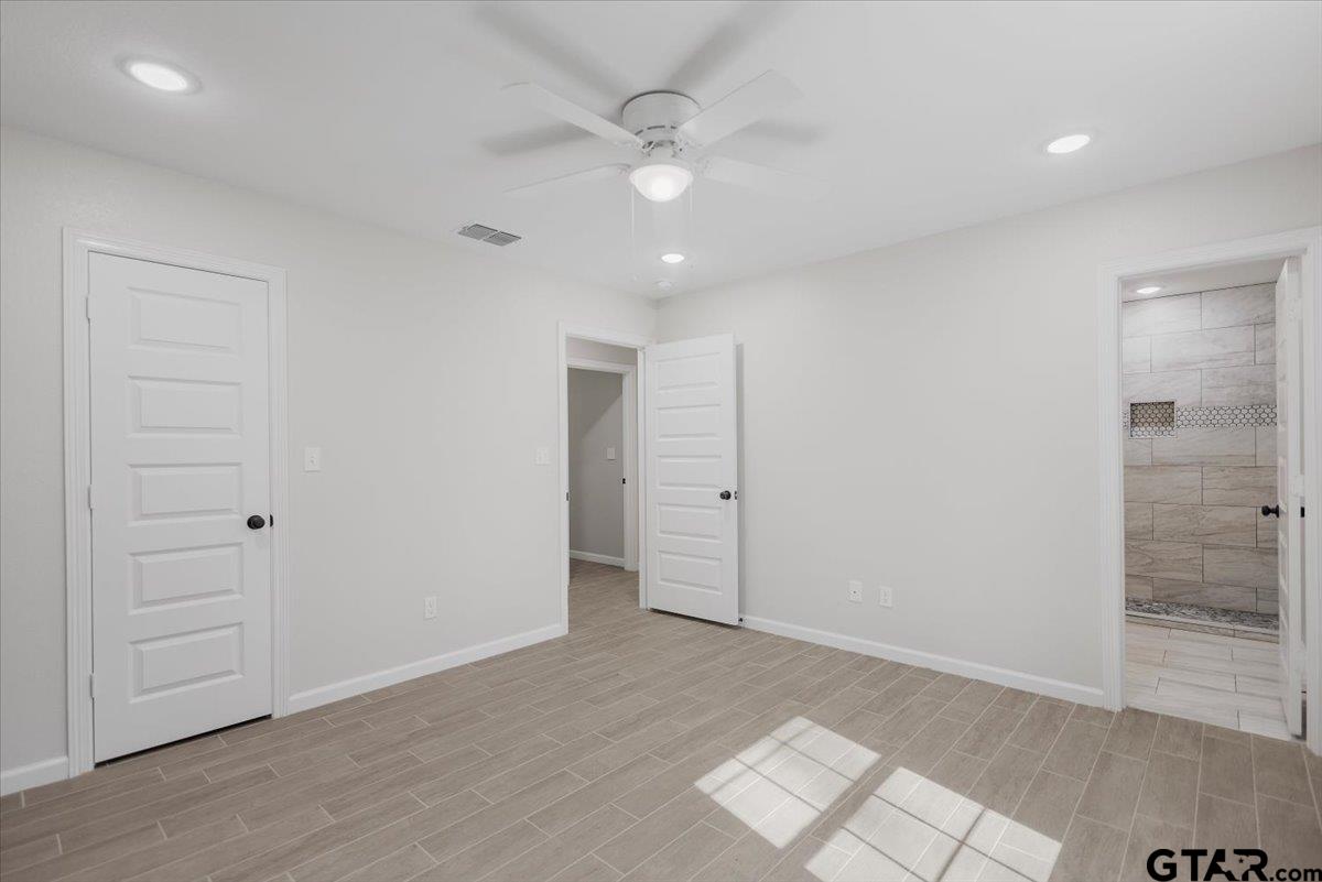 234 Sabinal Street Bullard, TX 75757 - Photo 20 of 30 wooden floor in an empty room with a bathroom