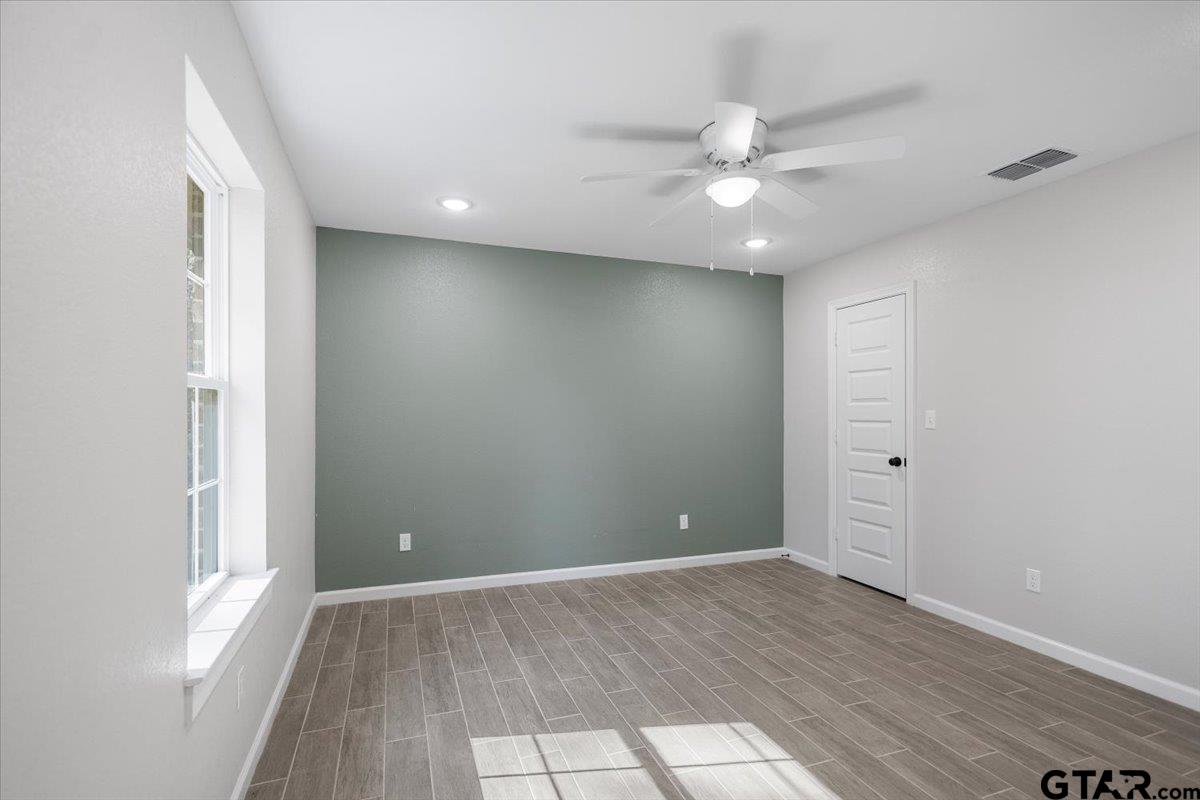 234 Sabinal Street Bullard, TX 75757 - Photo 21 of 30 wooden floor in an empty room with a window