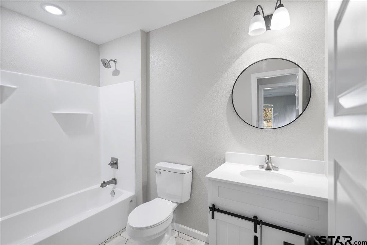 234 Sabinal Street Bullard, TX 75757 - Photo 23 of 30 a bathroom with a sink a mirror and a toilet