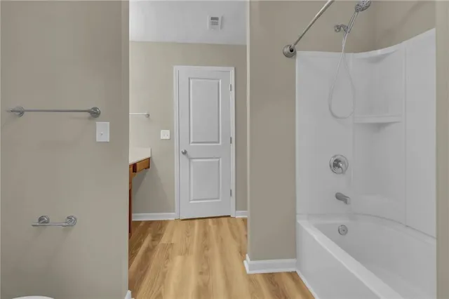 a bathroom with a bathtub and shower