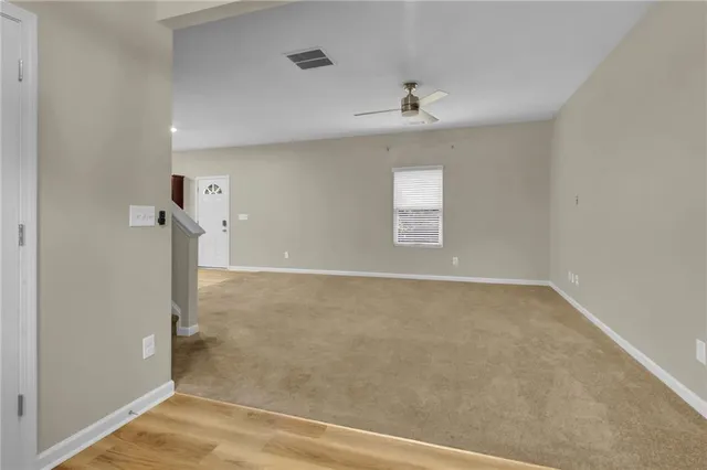 an empty room with windows and entrance