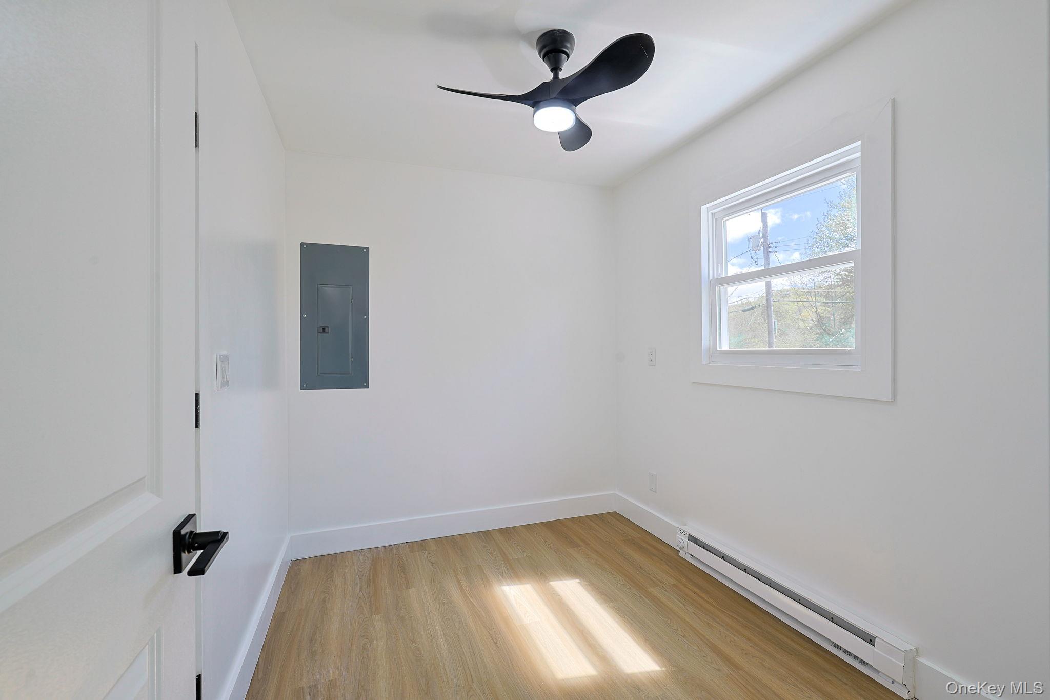 25 Overlook Road Woodbourne, NY 12788 - Photo 10 of 22 wooden floor in an empty room with a window