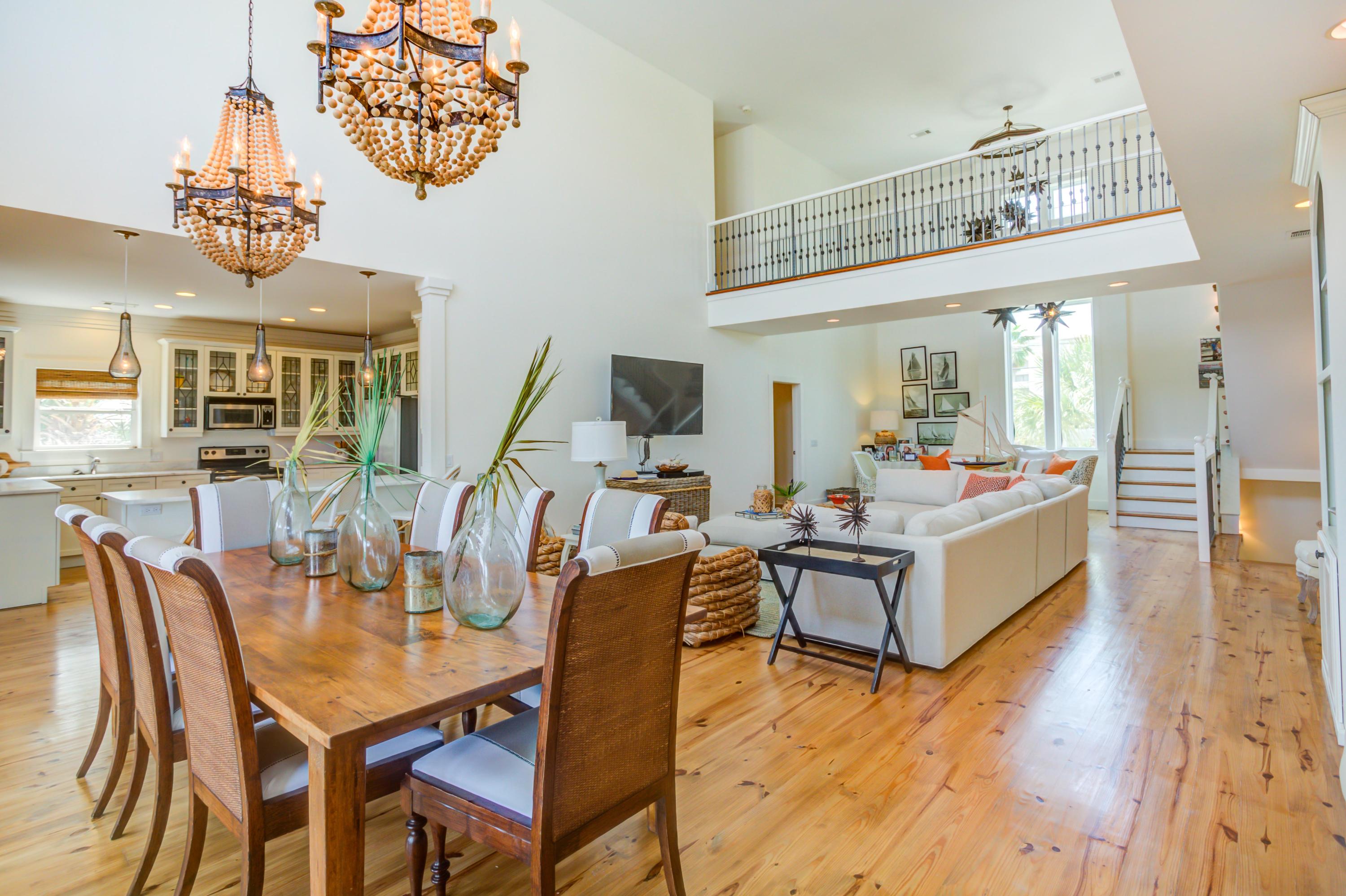 523 Gulf Shore Drive Destin, FL 32541 - Photo 11 of 78 a view of a dining room with furniture a chandelier and wooden floor