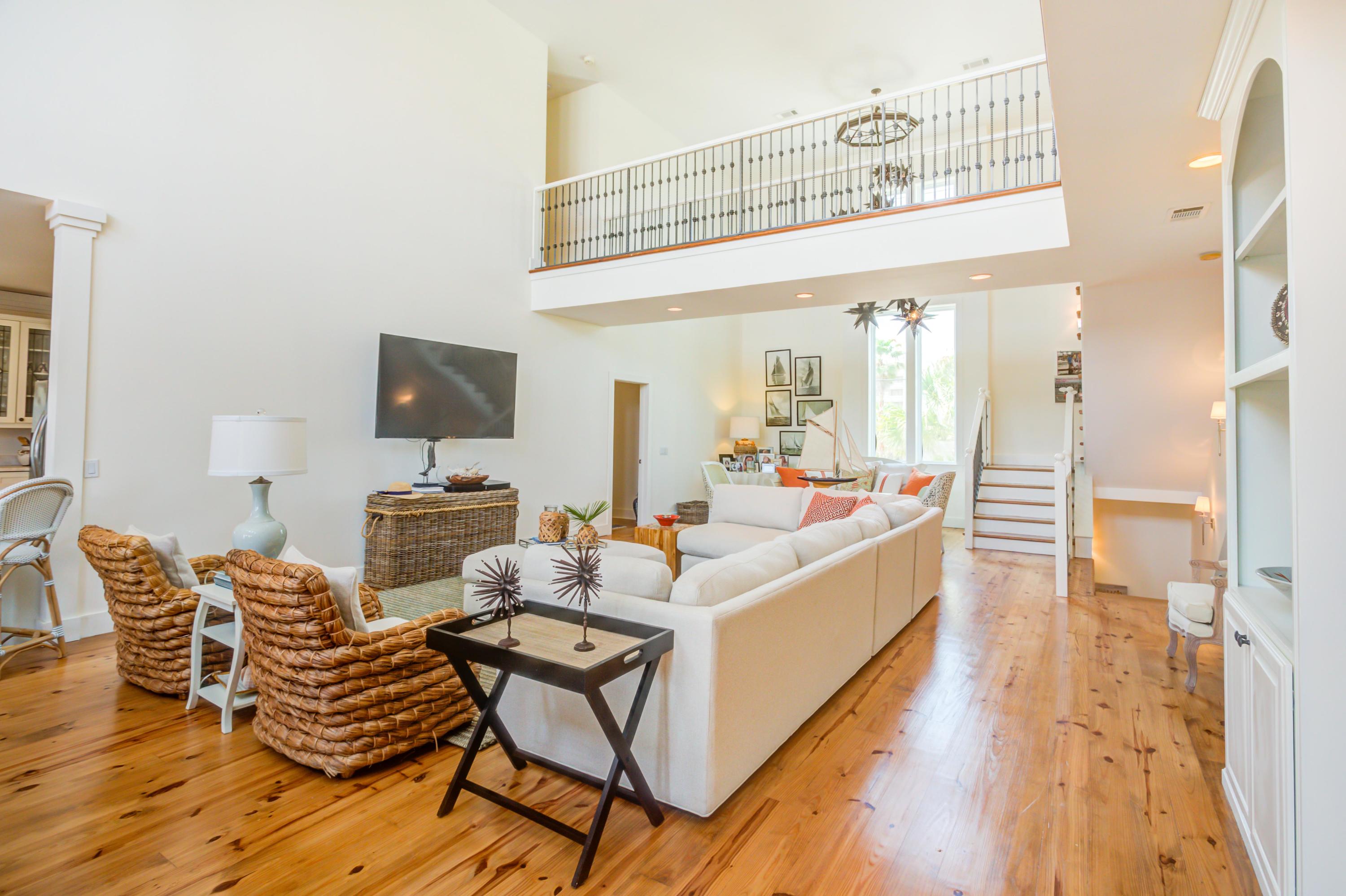 523 Gulf Shore Drive Destin, FL 32541 - Photo 13 of 78 a living room with furniture a flat screen tv and a wooden floor