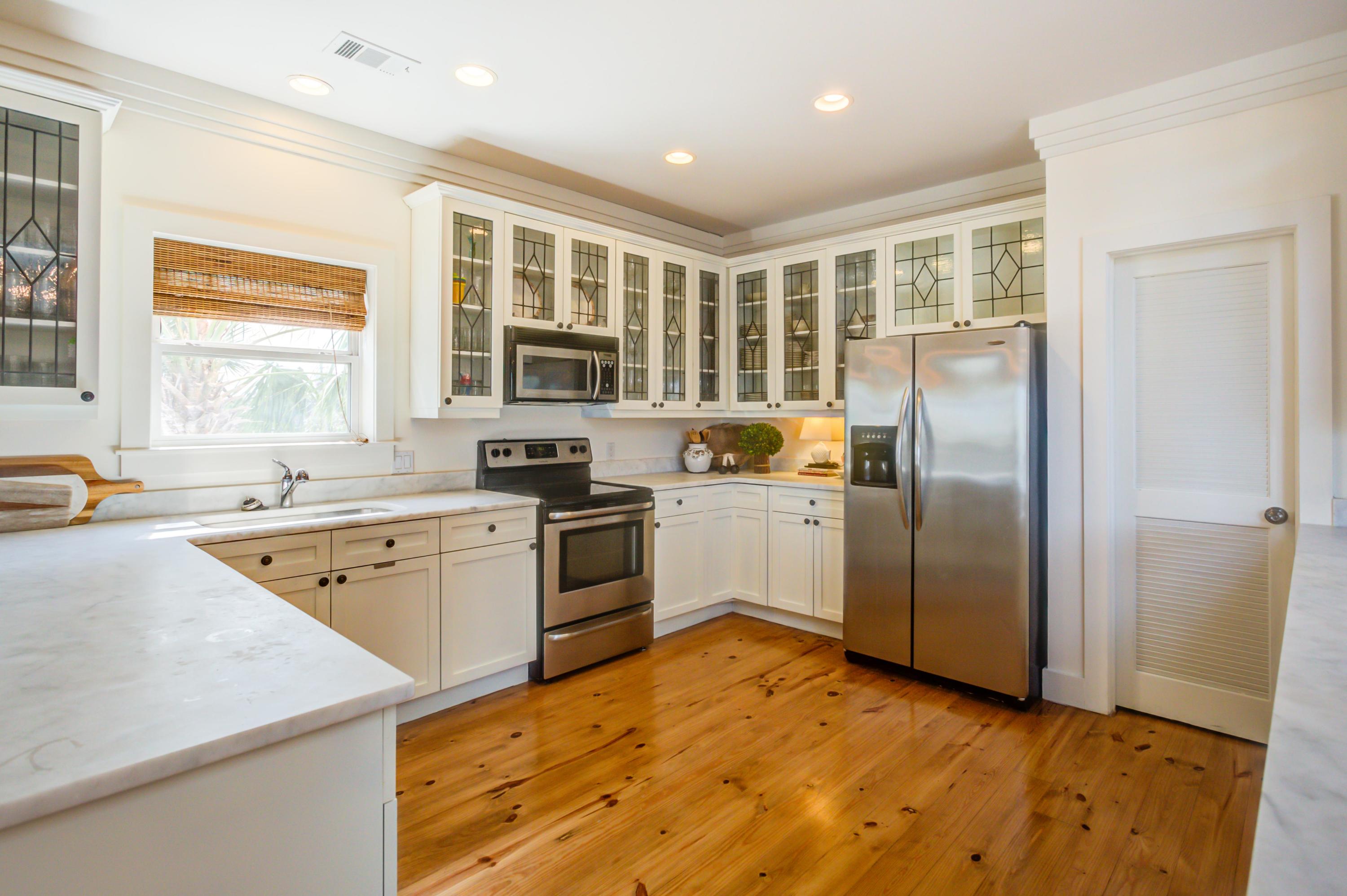 523 Gulf Shore Drive Destin, FL 32541 - Photo 18 of 78 a kitchen with a refrigerator and a sink