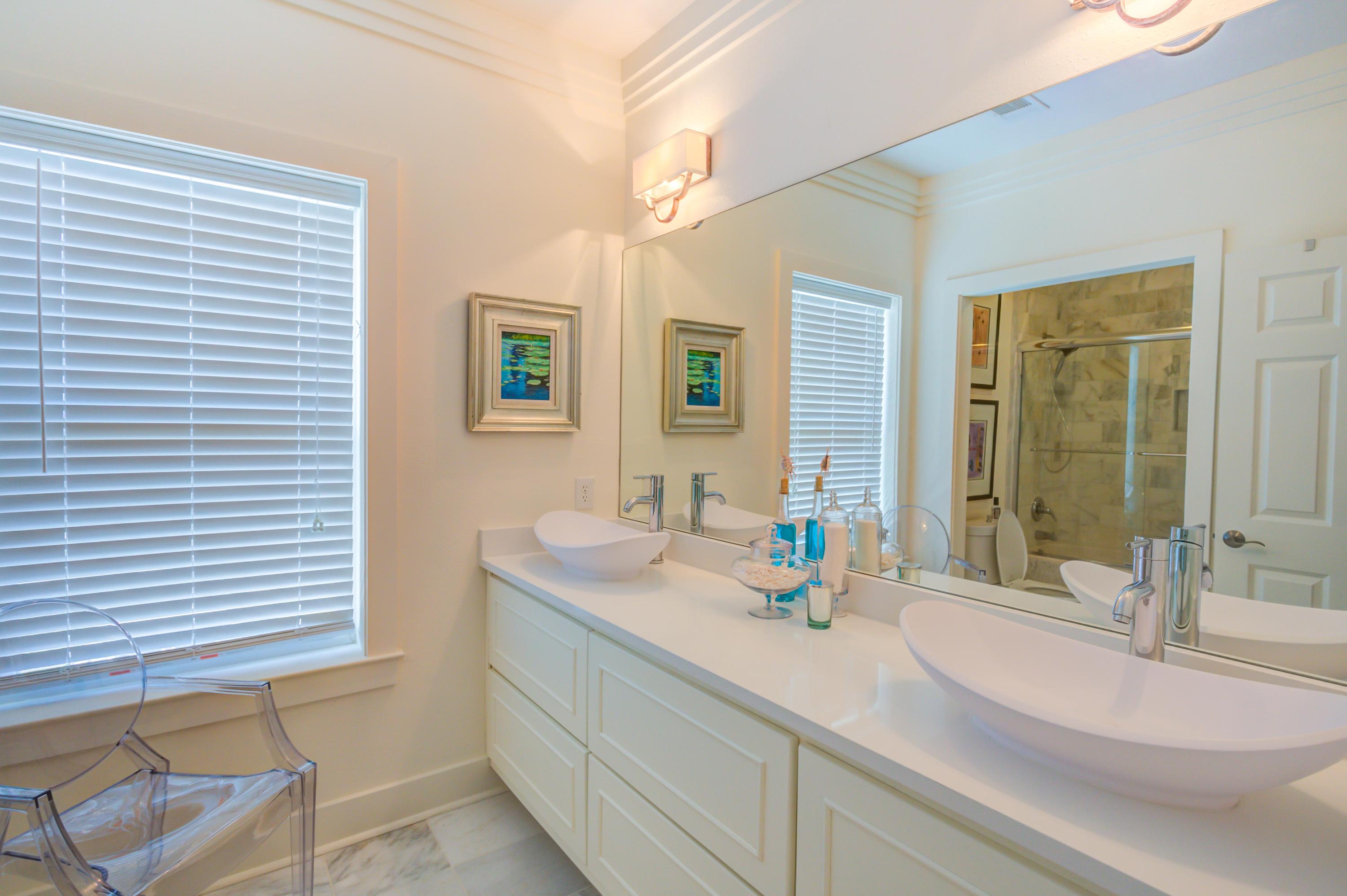 523 Gulf Shore Drive Destin, FL 32541 - Photo 38 of 78 a bathroom with a granite countertop sink and a mirror
