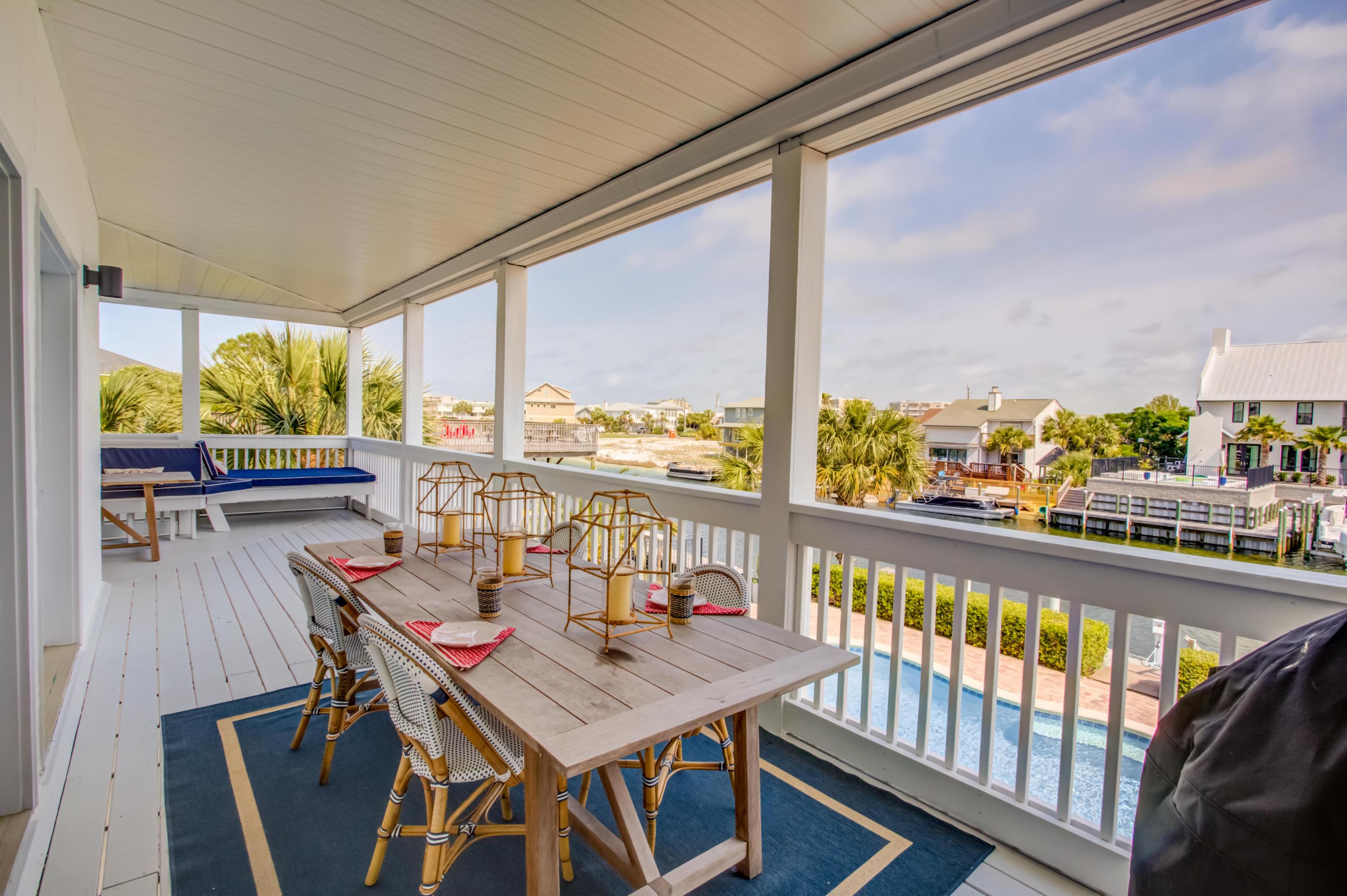 523 Gulf Shore Drive Destin, FL 32541 - Photo 41 of 78 a view of a balcony with chairs and wooden floor