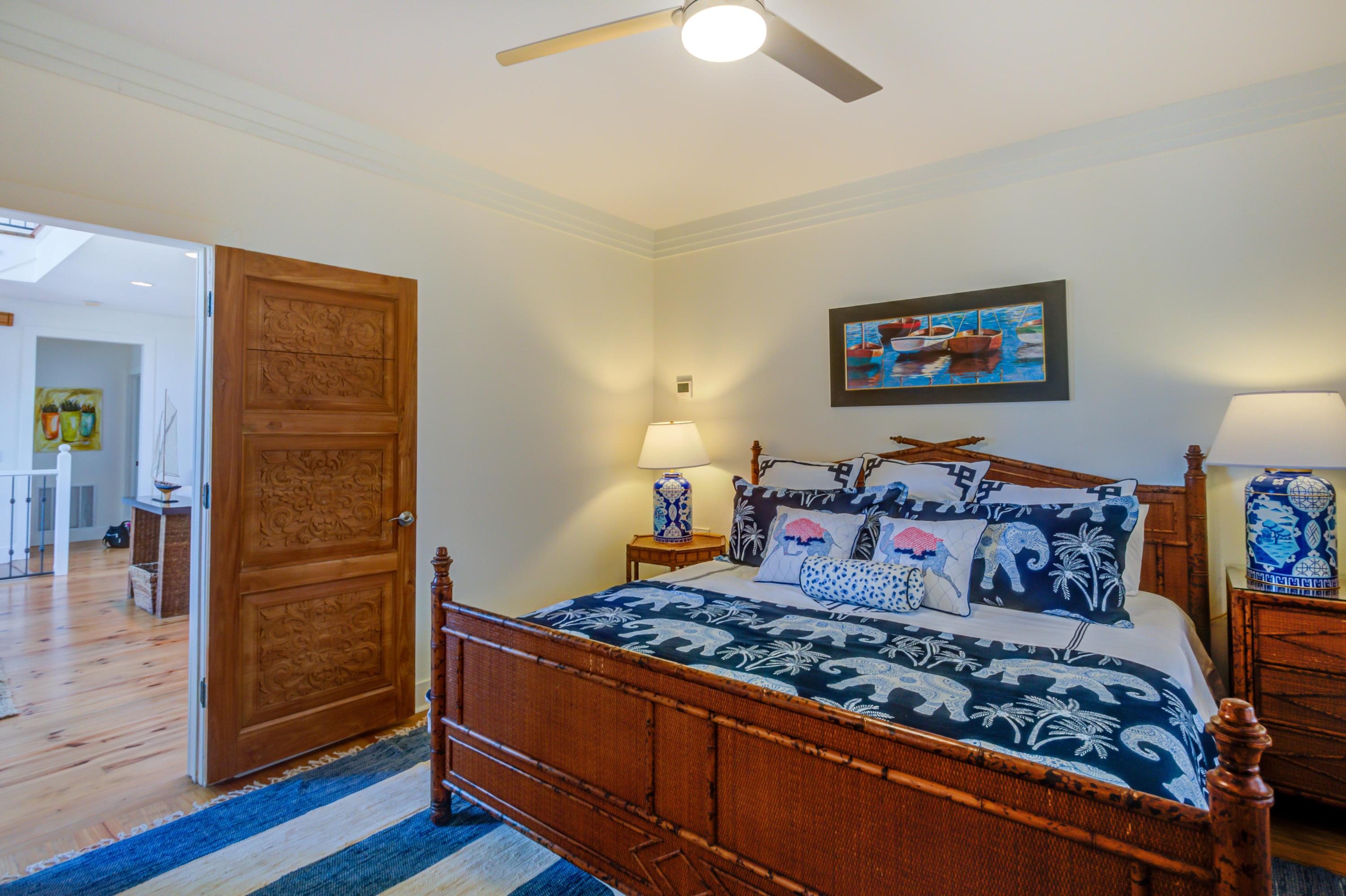 523 Gulf Shore Drive Destin, FL 32541 - Photo 43 of 78 a bedroom with a bed and a lamp on dresser