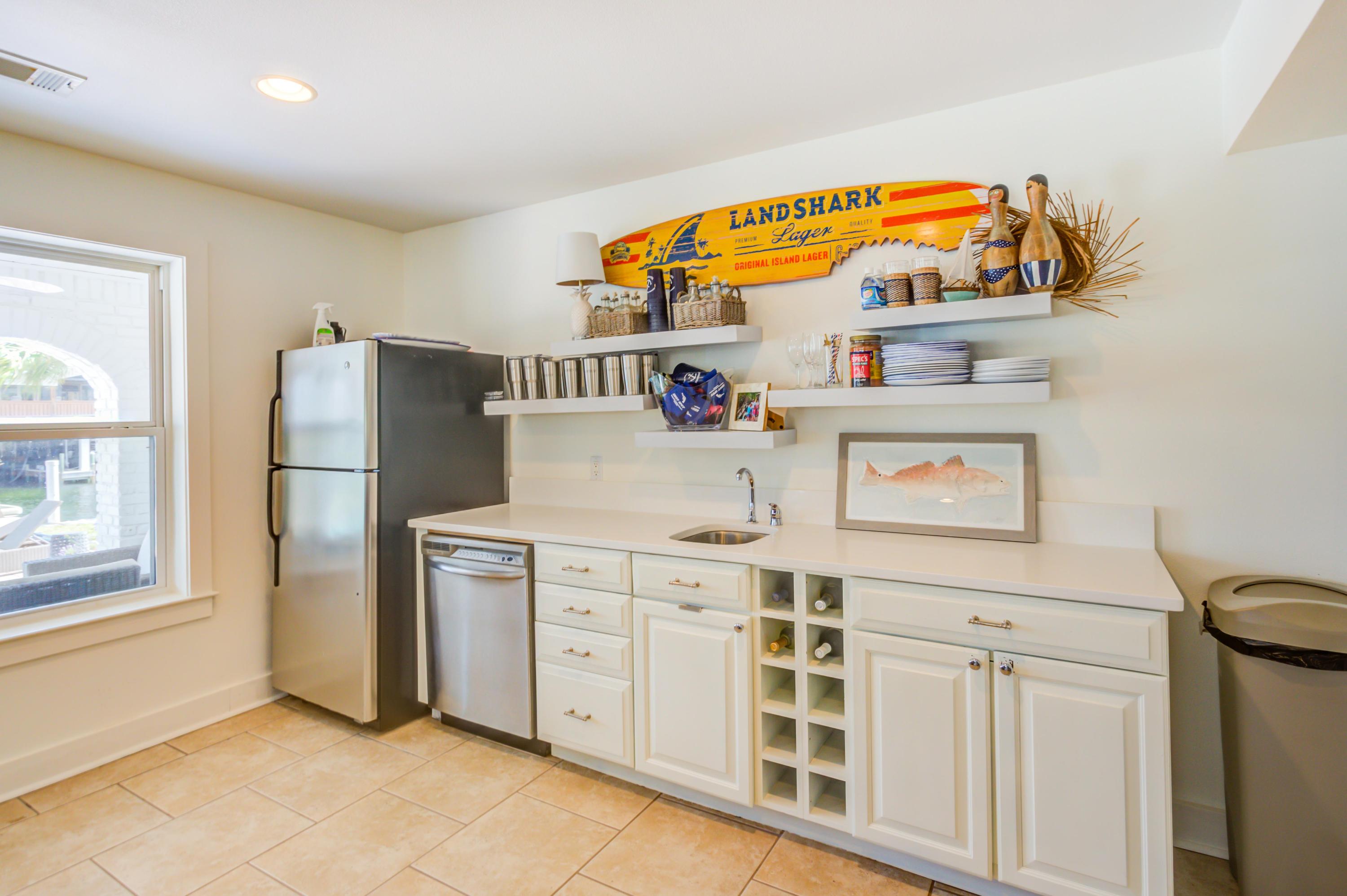 523 Gulf Shore Drive Destin, FL 32541 - Photo 52 of 78 a utility room with stainless steel appliances wooden floor and window