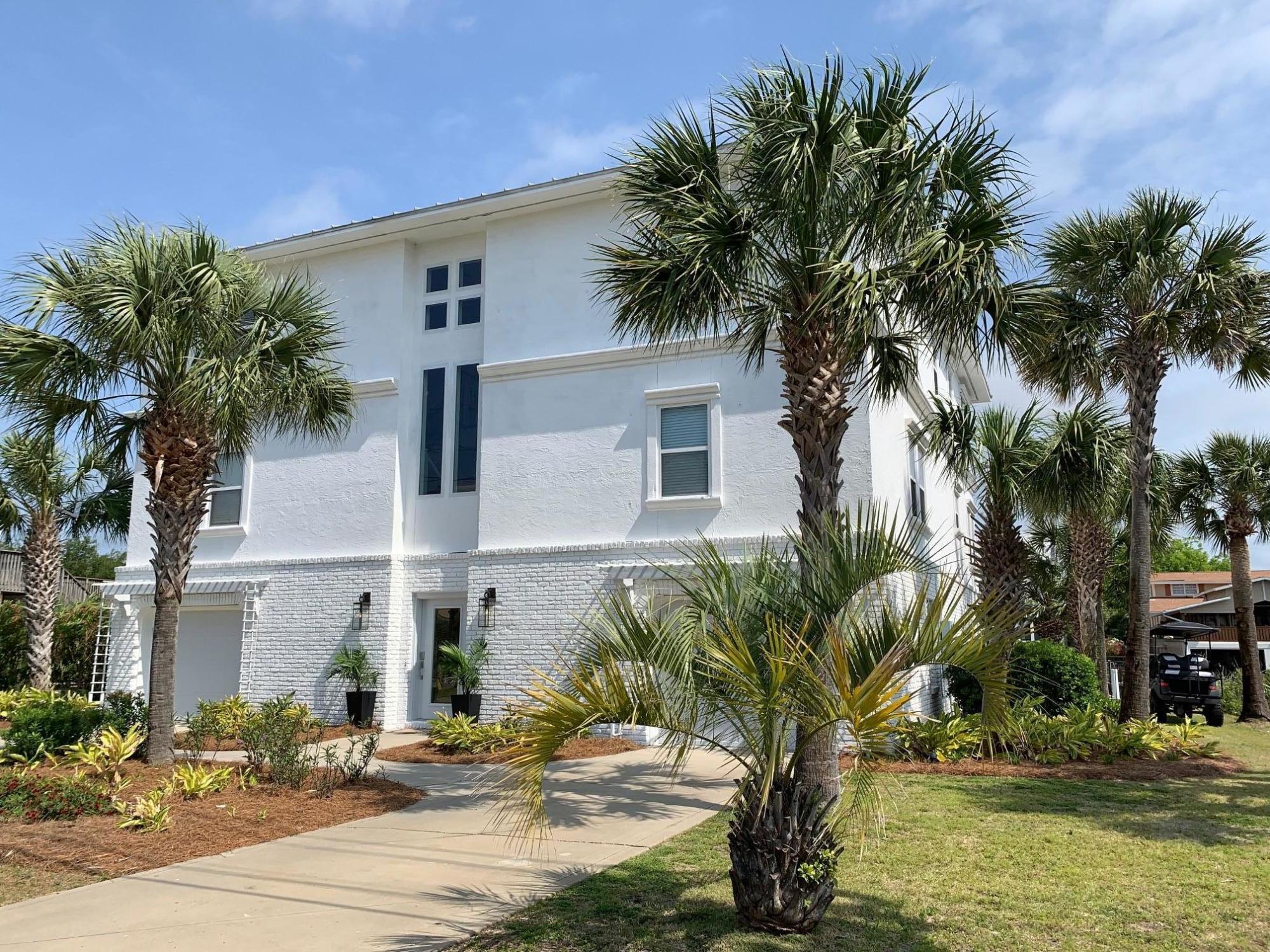 523 Gulf Shore Drive Destin, FL 32541 - Photo 9 of 78 a palm tree sitting in front of a house with a yard