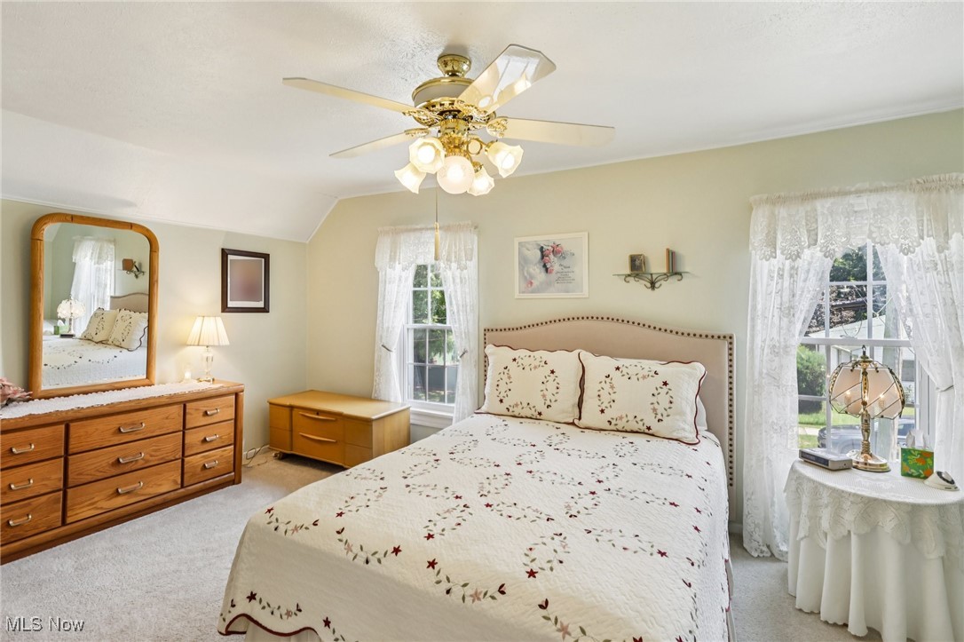 10818 Dixon Road Cleveland, OH 44111 - Photo 25 of 44 Bedroom with light colored carpet, lofted ceiling, and ceiling fan