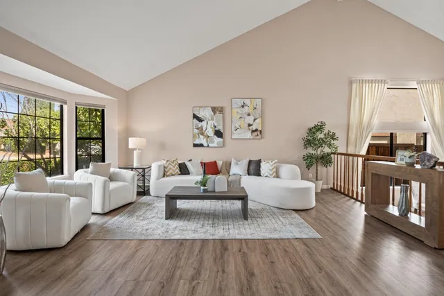 a living room with furniture and a wooden floor