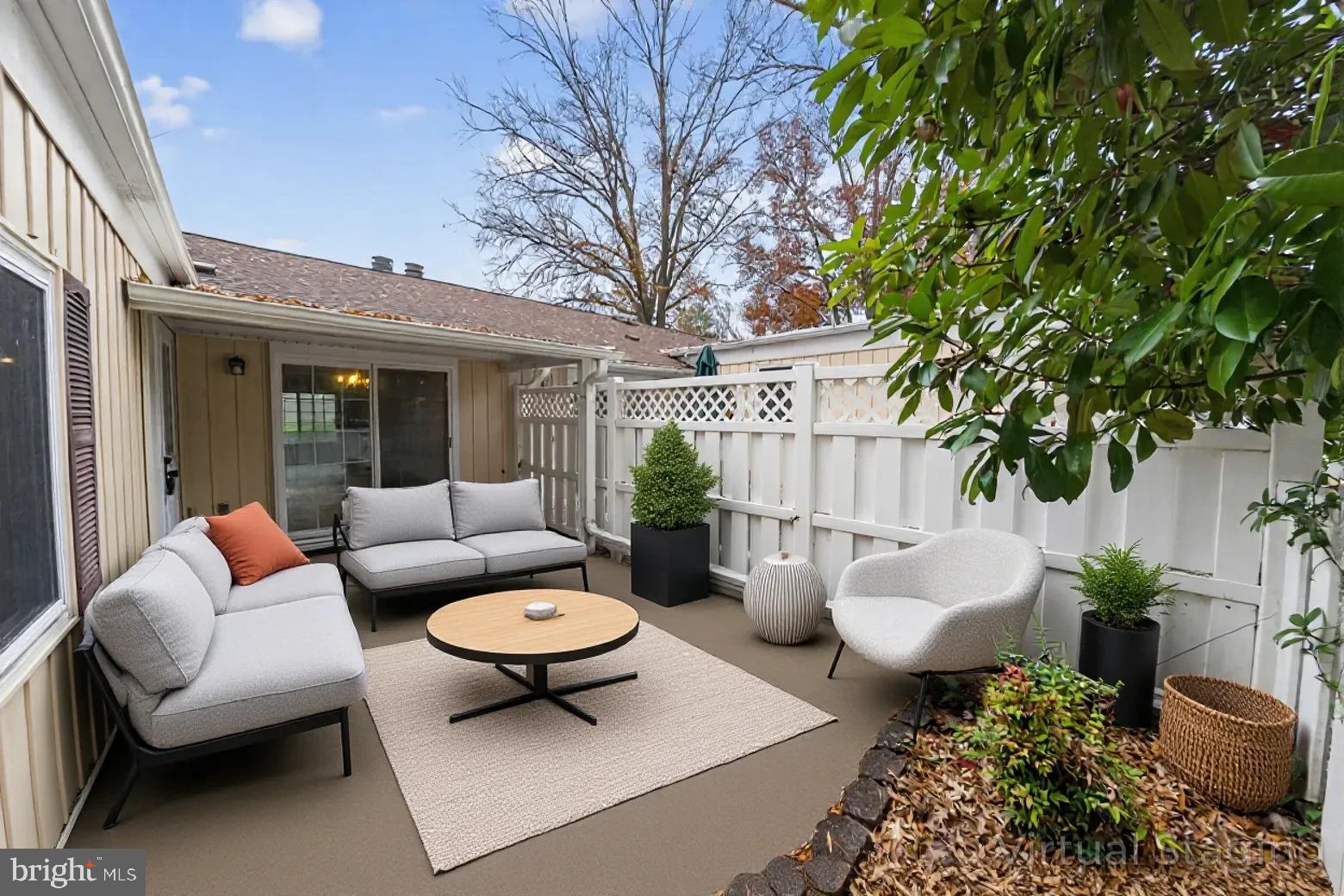 14603 Edelmar Drive, Unit 132A Silver Spring, MD 20906 - Photo 3 of 52 a view of a patio with couches table and chairs and potted plants