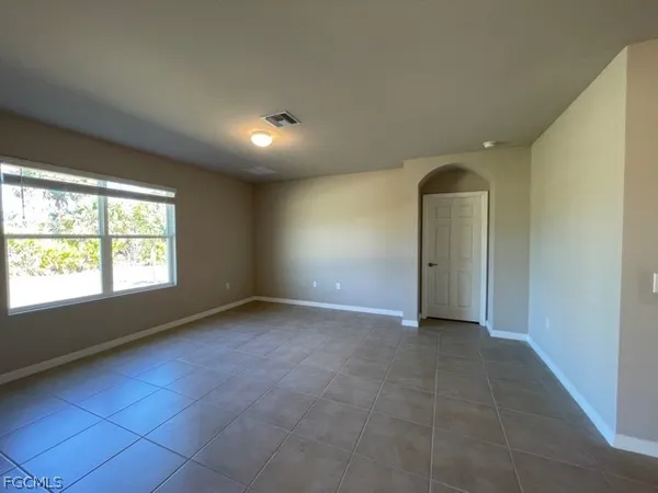 an empty room with windows and entrance