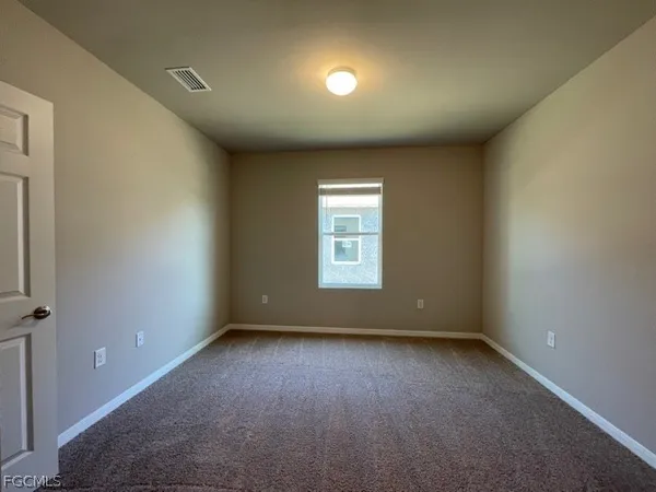 an empty room with a empty space and windows