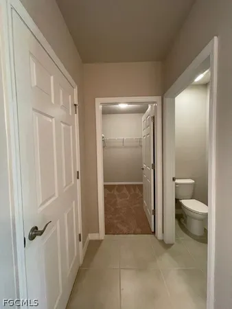 a bathroom with a granite countertop toilet and a shower
