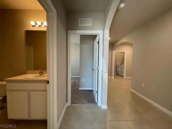 a view of a hallway with closet and a livingroom