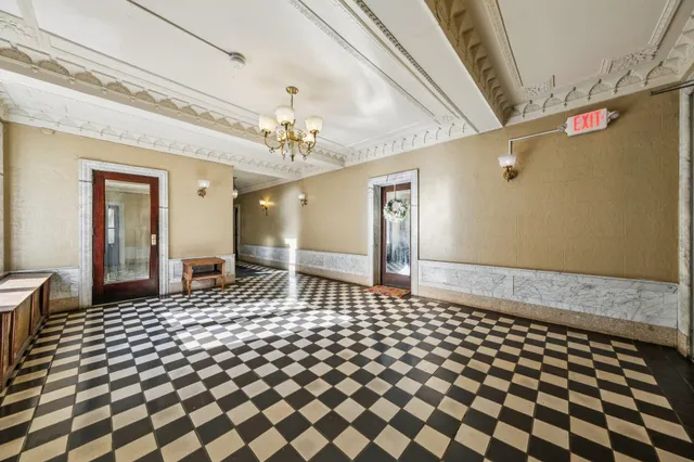 a bathroom with a black and white checkered floor