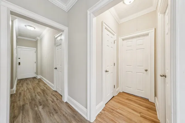 a view of a hallway with wooden floor