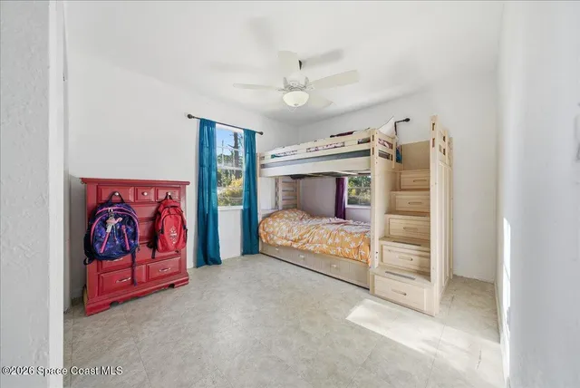 a bathroom with a granite countertop toilet a sink and a mirror
