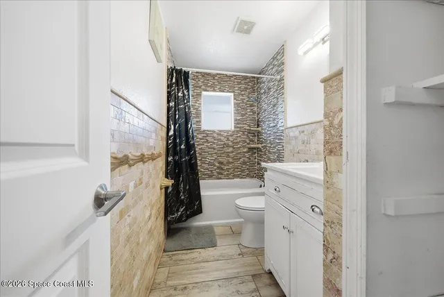 a spacious bedroom with a bed and a window