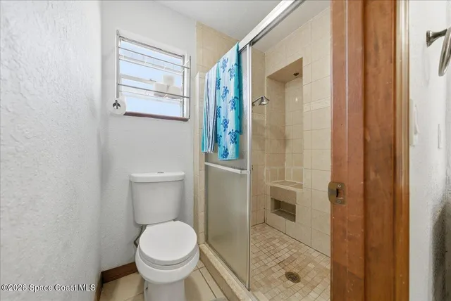 a view of a hallway with wooden shelves