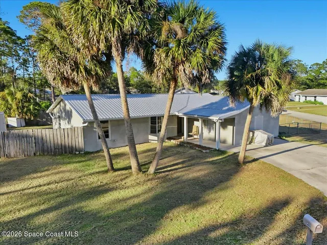 a view of a house with backyard and a slide