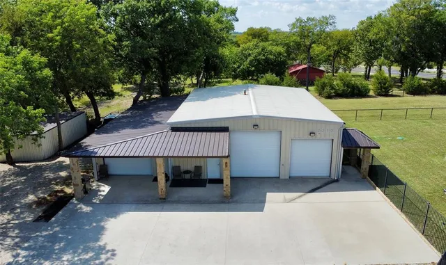 a view of a patio with a table and chairs under an umbrella