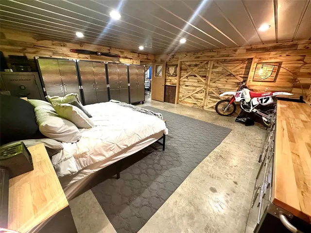 a bedroom with bed and a car parked